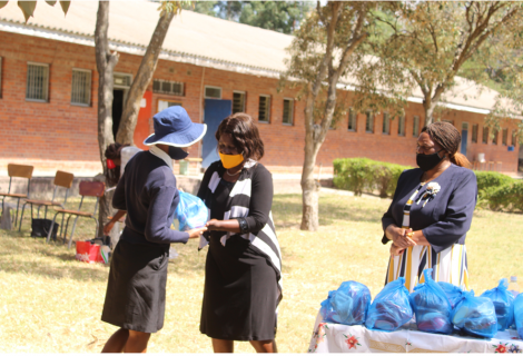 One of the students receiving the hygiene pack from the Harare Metropolitan Province, Deputy Director local Government, Mrs Mubaiwa