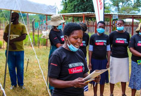 Hilder Shumbahuru, Gender Champion from Chigondo village, Hwedza, speaking during the IWD celebrations in Nkayi while other women look on 