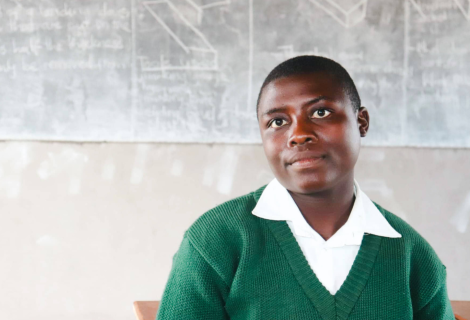 Yollanda sitting in the classroom of her school