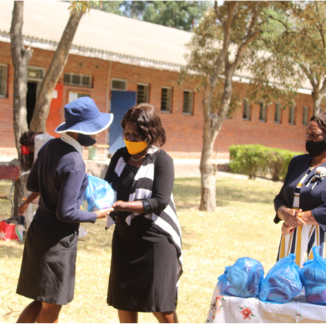 One of the students receiving the hygiene pack from the Harare Metropolitan Province, Deputy Director local Government, Mrs Mubaiwa