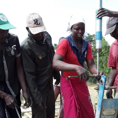 Beauty Makoto, a pump minder from Nyamaropa, Nyanga repairing a borehole