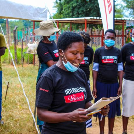 Hilder Shumbahuru, Gender Champion from Chigondo village, Hwedza, speaking during the IWD celebrations in Nkayi while other women look on